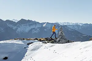 Mountaineer looks over snow-covered mountains