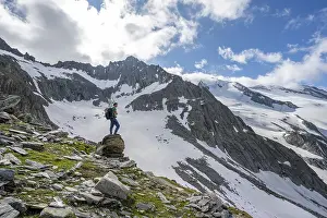 Mountaineer on a rock, rocky mountain peak Furtschaglspitze in the background