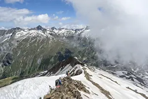 Mountaineer on a rocky ridge with snow