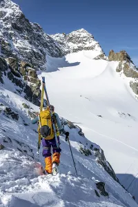 Mountaineer with skis at the fork Porta d'Es-cha