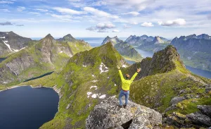 Mountaineer stretching his arms in the air
