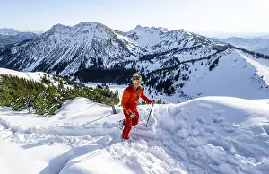 Mountaineer at the summit of the Aiplspitz in the snow