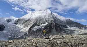 Mountaineer in front of the summit of Mont Blanc de Cheilon and glacier Glacier de Cheilon
