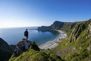 Mountaineer with view of coastal landscape
