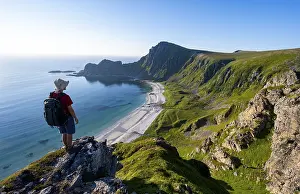 Mountaineer in front of view of coastal landscape