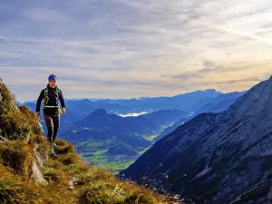 Mountaineer walking on a narrow path above the Salzach valley