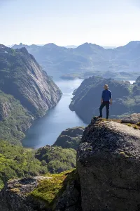 Mountaineer, young man in front of mountain landscape
