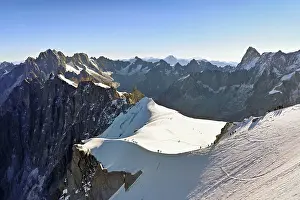 Framed Print : Mountaineers climb over a snow-covered ridge