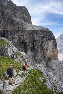 Three mountaineers on a hiking trail