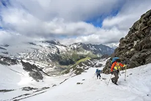 Two mountaineers on a hiking trail in the snow