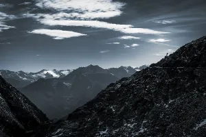 Mountaineers on mountain ridge in the background glaciated mountains