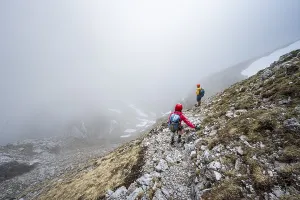 Two mountaineers on a narrow hiking trail