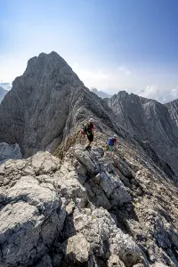 Two mountaineers on a rocky narrow mountain path