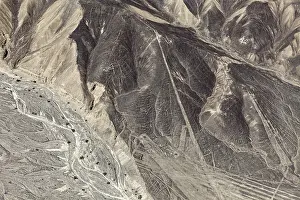 A mountainous country with a recognizable line pattern flying over the desert