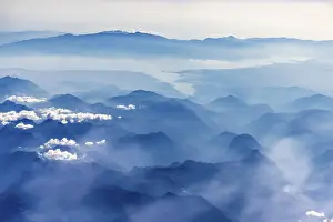 Mountains and clouds, mountain peaks in blue light