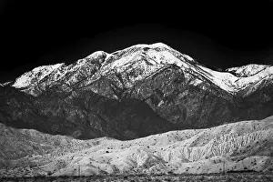 Mountains covered with snow under a contrasty black-and-white image of the Santa Rosa