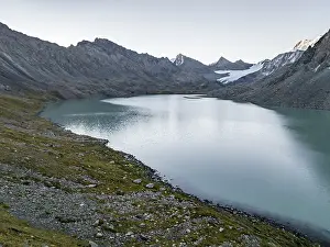 Mountains with glacier, mountain pass and mountain lake Ala-Kul Lake