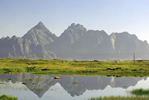 Mountains reflected in a calm body of water