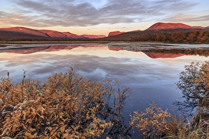Mountains reflected in lake, autumn colours