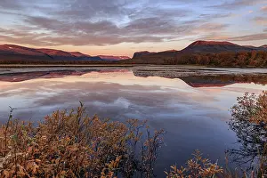 Mountains reflected in lake, autumn colours