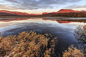 Mountains reflected in lake, autumn colours