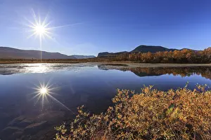 Mountains reflected in lake, autumn colours