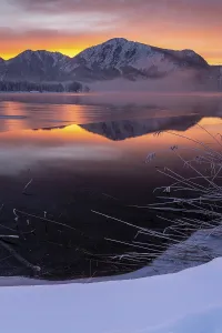 Mountains reflected in lake, dawn