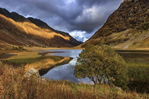 Mountains reflected in lake, evening light
