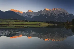 Mountains reflected in lake, evening light