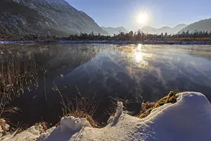 Mountains reflected in lake, evening light