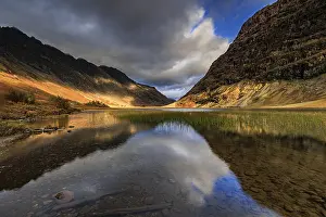 Mountains reflected in lake, evening light