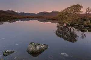 Mountains reflected in lake, morning light