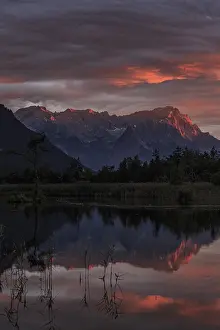 Mountains reflected in lake, sunset