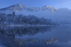 Mountains reflected in lake, winter