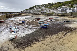 MOUSEHOLE HARBOUR, CORNWALL, UK - MAY 11 : View of Mousehole Harbour at low tide in Cornwall on May 11