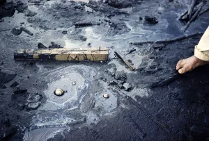 Moving stream of tar carrying pieces of wood, La Brea Pitch Lake, Trinidad, early 1960s
