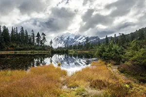 Mt. Shuksan in clouds, glacier with snow with reflection in Picture Lake