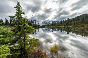Mt. Shuksan in clouds, glacier with snow with reflection in Picture Lake