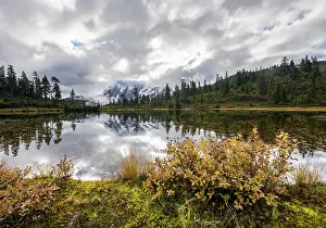 Mt. Shuksan in clouds, glacier with snow with reflection in Picture Lake