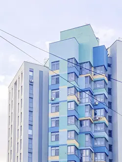 Multi-story residential building in blue and yellow colors