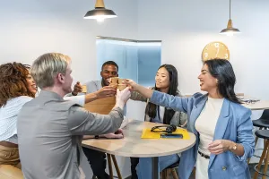 Multiethnic business team toasting together with coffee