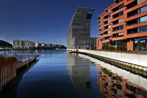 The Munch Museum is reflected in the clear water of Bjovika in Oslo