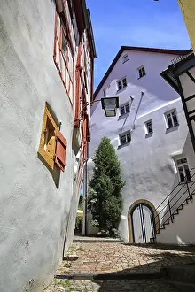 Framed Print : Narrow alley with half-timbered houses and nostalgic lantern under blue sky in Bad Wimpfen