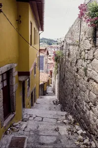 Narrow alley with stone steps in the old town of Porto