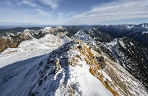 Narrow rocky snowy ridge of the Ammergauer Hochplatte