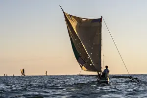Framed Print : Native fisherman in traditional Pirogue outrigger boat on open sea Framed Print : Native fisherman in traditional Pirogue outrigger boat on open sea