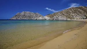 Category Mountain Landscapes Prints: Natural beach with turquoise waters and a picturesque mountain backdrop under a clear sky