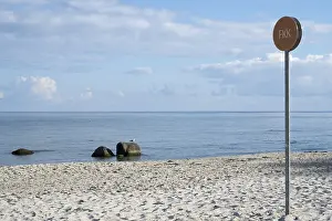 Naturist sign on the beach, sandy beach