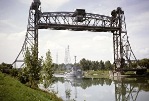 US Navy boat passing under the vertical lift drawbridge, Welland Canal, Saint Lawrence Seaway, Great Lakes, Ontario, Canada, North America 1963, North America