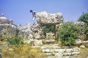 Neolithic temples of Skorba prehistoric archaeological site, Mgarr, Malta, Europe 1971 young man climbing on stones, Europe